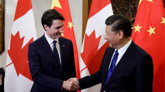 Prime Minister Justin Trudeau shakes hands with President Xi Jinping