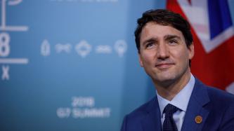 Prime Minister Justin Trudeau smiles at the cameras.