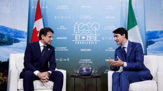 Prime Minister Trudeau sits and talks with PM Giuseppe Conte.