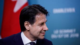 PM Giuseppe Conte listens to PM Trudeau during the discussion.
