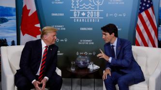 Prime Minister Trudeau sits and talks with President Donald Trump.