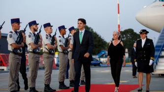 PM Trudeau walks down a red carpet