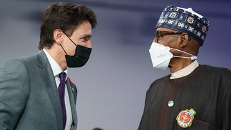 Prime Minister Justin Trudeau and Nigerian President Muhammadu Buhari stand and look at one another