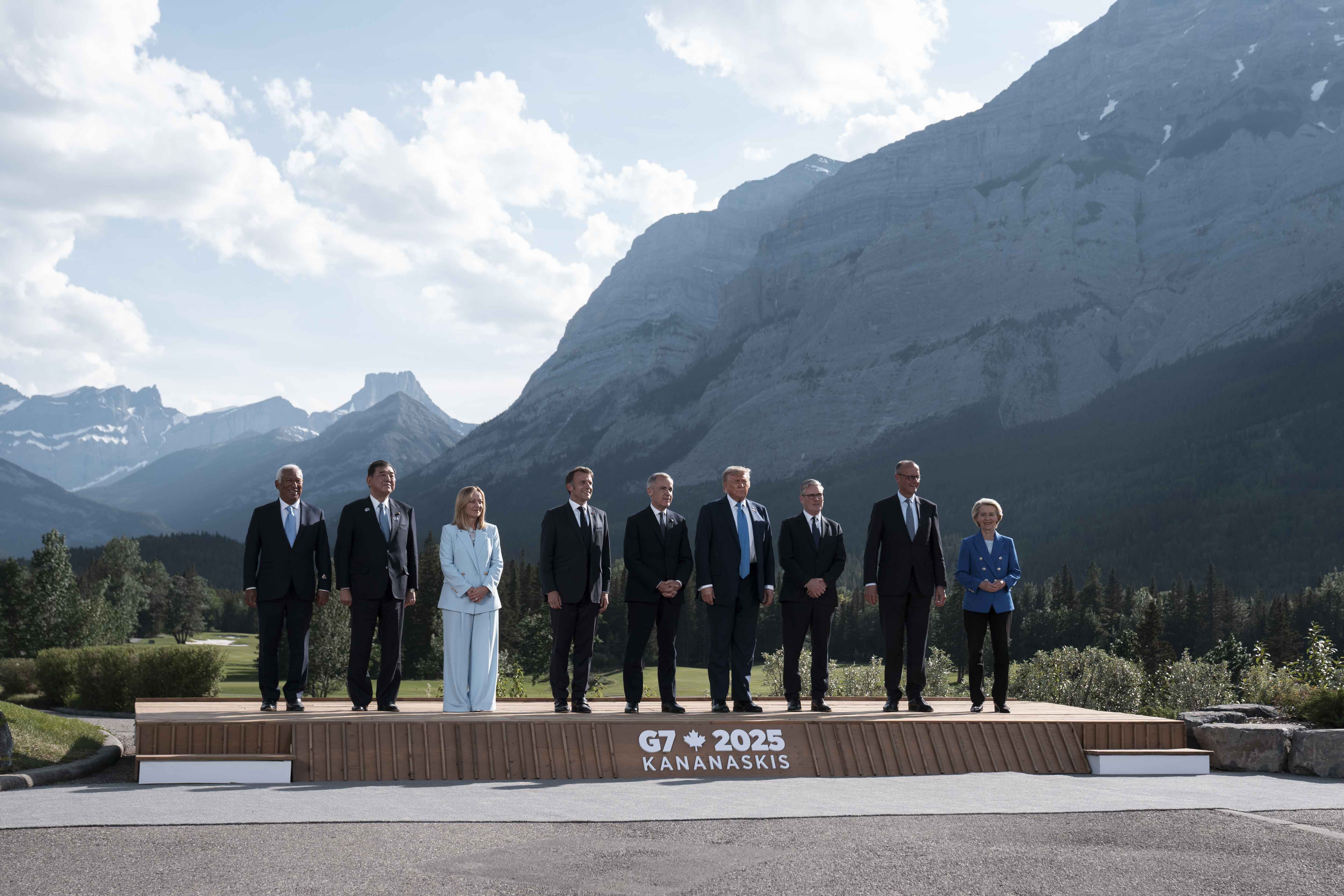 G7 leaders stand for a family photo. The Kananaskis Range mountains are pictured in the background.
