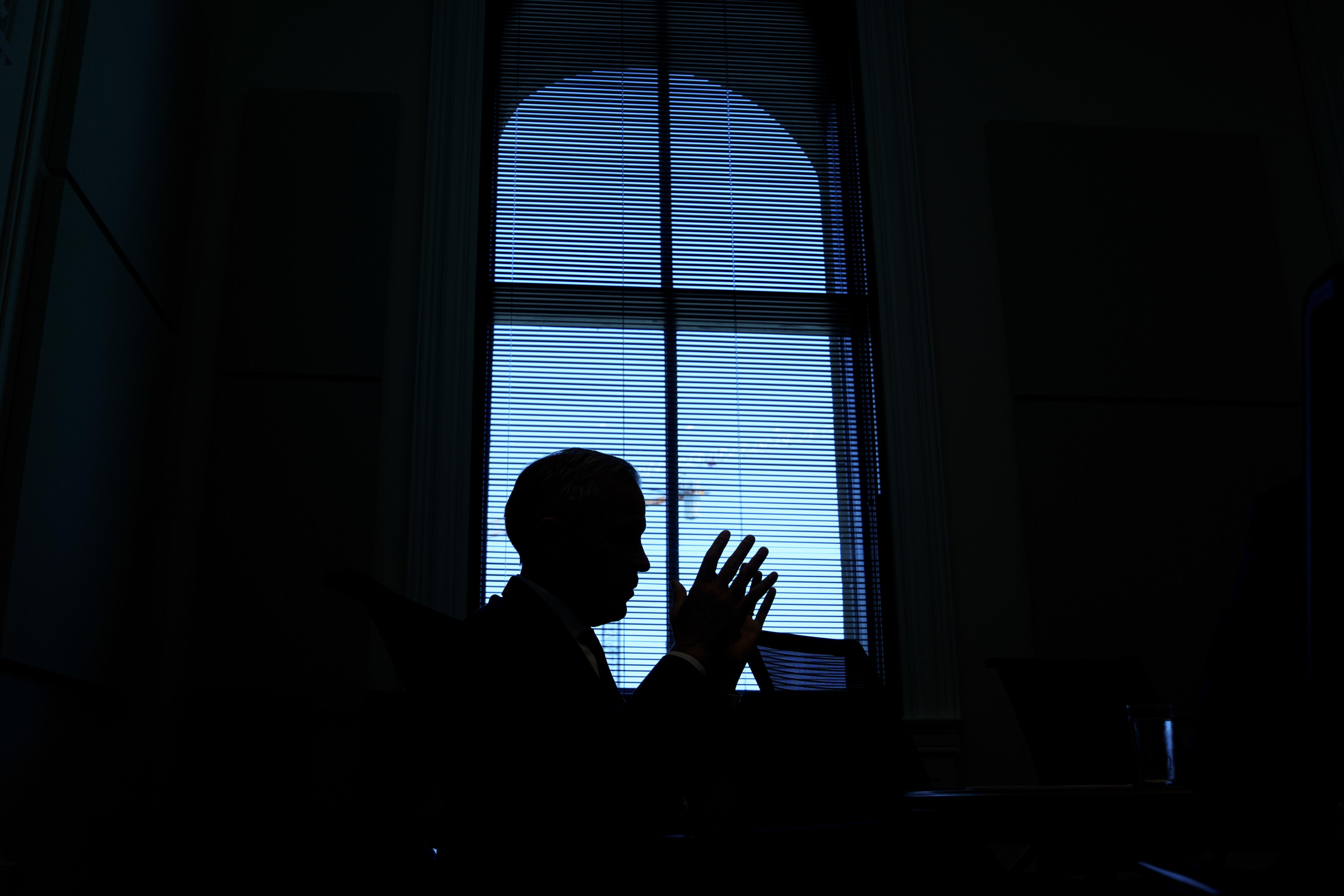 Backlit silhouette of Prime Minister Carney after a meeting with chief executive officers of the automotive industry.