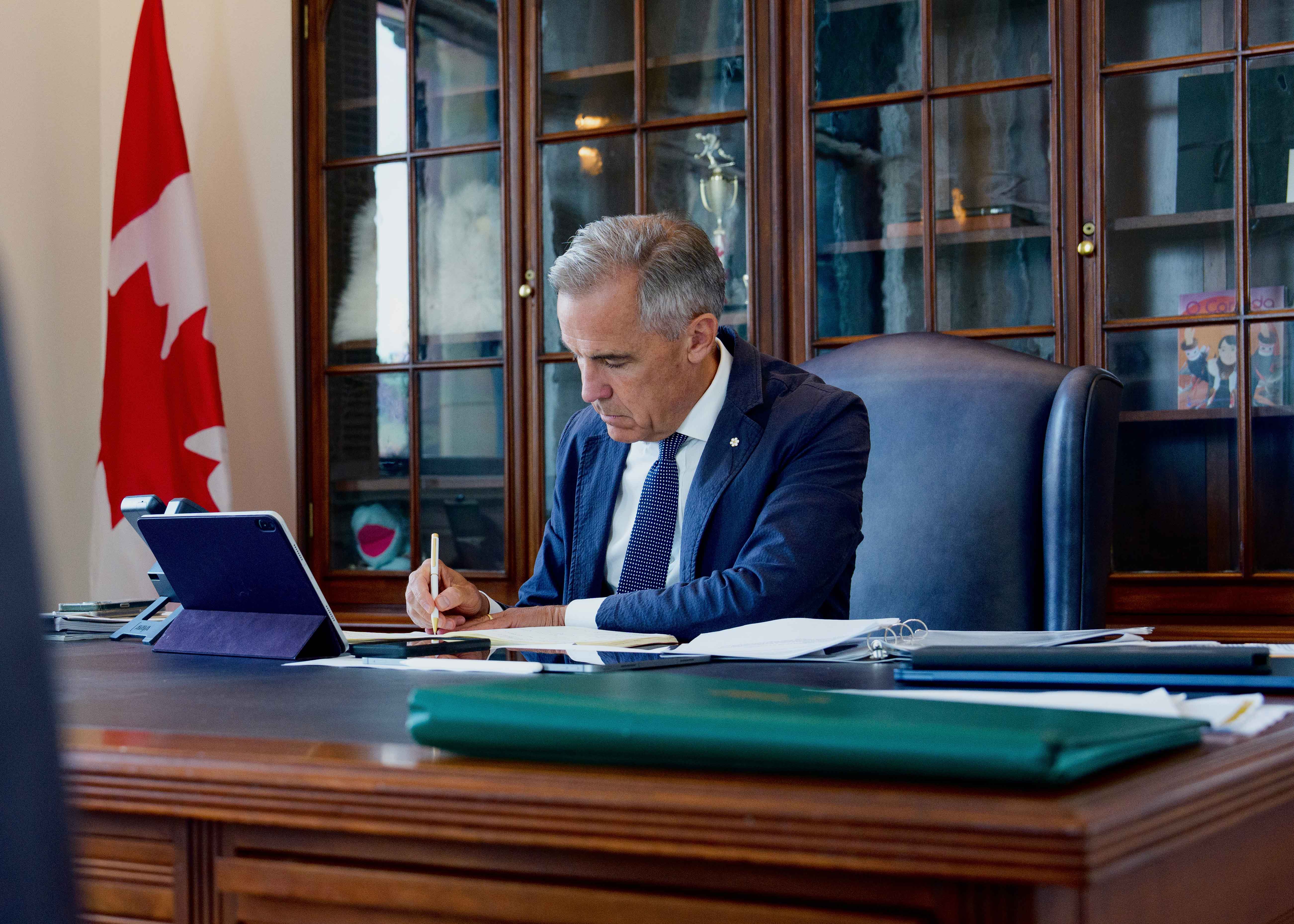 Prime Minister Mark Carney is sitting in his office at West Block on Parliament Hill