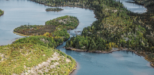 Wooded peninsula characterized by dense forest, rocky coastline and intricate waterways.