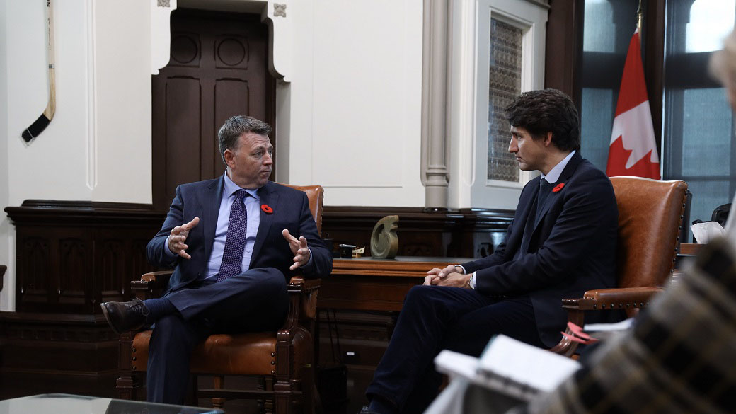 Prime Minister Justin Trudeau sits with Prince Edward Island Premier Dennis King