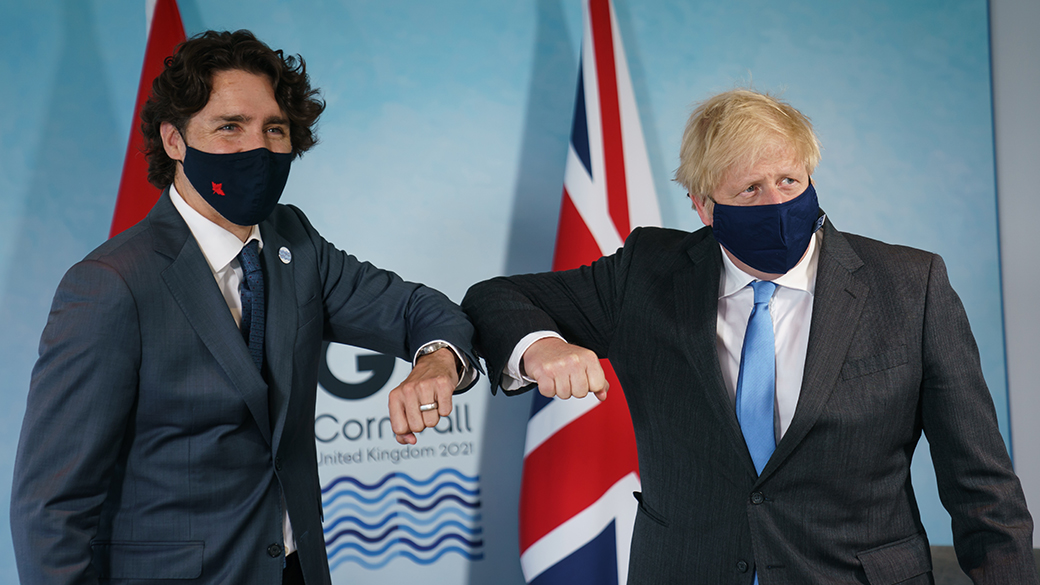 Prime Minister Justin Trudeau bumps elbows with Prime Minister Boris Johnson at the G7 Leaders' Summit