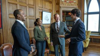 Photo number 1 from the photo gallery Prime Minister Justin Trudeau speaks with retired CFL player Henry Burris, Nicole Burris, and MP David McGuinty