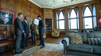 Photo number 2 from the photo gallery Prime Minister Justin Trudeau speaks with retired CFL player Henry Burris, Nicole Burris, and MP David McGuinty