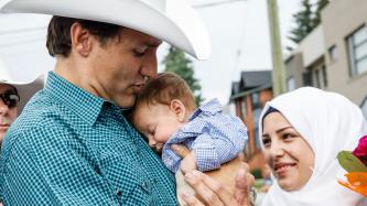 Photo number 1 from the photo gallery Prime Minister Trudeau meets Justin-Trudeau Adam Bilal, the son of newly arrived Syrian refugees, during a pancake breakfast in Calgary