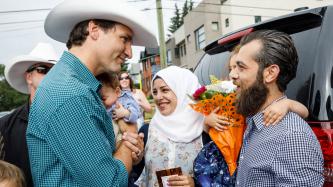 Photo number 2 from the photo gallery Prime Minister Trudeau meets Justin-Trudeau Adam Bilal, the son of newly arrived Syrian refugees, during a pancake breakfast in Calgary