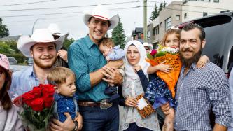 Photo number 4 from the photo gallery Prime Minister Trudeau meets Justin-Trudeau Adam Bilal, the son of newly arrived Syrian refugees, during a pancake breakfast in Calgary