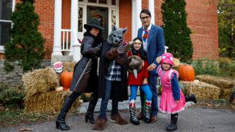 Prime Minister Justin Trudeau poses with his wife and children in Halloween costumes in front of their home