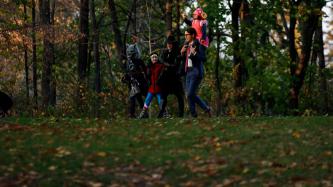 Prime Minister Justin Trudeau and his family wear Halloween costumes and walk together in the woods on Halloween