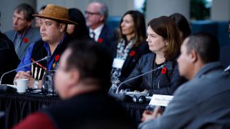 Minister Jane Philpott and other officials are shown listening during the forum
