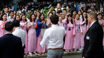 Prime Minister Justin Trudeau is greeted by a group of excited students at Ton Duc Thang University