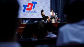 Prime Minister Justin Trudeau speaks during a panel discussion, while a female panelist and the audience look on