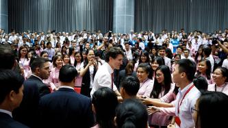 Prime Minister Justin Trudeau speaks to a group of students in an auditorium at Ton Duc Thang University