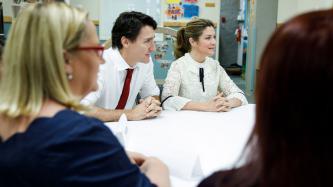 Prime Minister Justin Trudeau and Sophie Grégoire Trudeau listen during a meeting at the YWCA Crabtree Corner Community Resource Centre