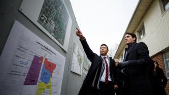 Prime Minister Justin Trudeau is shown a map of the Lawrence Heights Revitilization Project at the building site