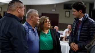 Prime Minister Trudeau listen to  survivors of the residential schools