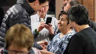 Prime Minister Trudeau holds hands with a residential school survivor