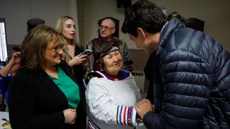 Prime Minister Trudeau shakes hands with an attendee