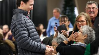 Prime Minister Trudeau laughs with one of the attendees