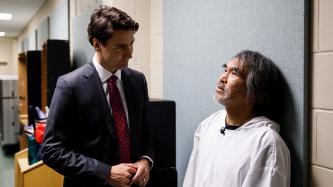 Prime Minister Trudeau listens to residential school survivor Toby Obed in a private discussion