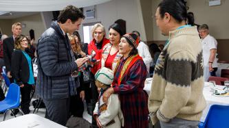 Prime Minister Trudeau accepts a gift from a member of the indigenous community