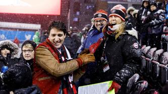 Prime Minister Justin Trudeau chats with fans in the stands at the Grey Cup
