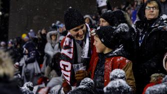 Prime Minister Justin Trudeau laughs with his son Xavier in the stands