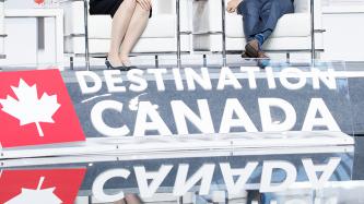 Prime Minister Justin Trudeau listens while an emcee asks a question during a panel discussion