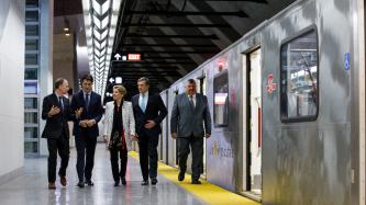 Prime Minister Justin Trudeau, Premier Kathleen Wynne, Mayor John Tory and others walk on a newly opened subway platform