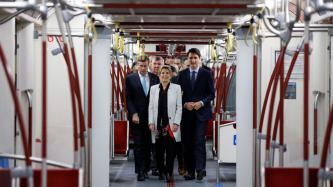 Prime Minister Justin Trudeau, Premier Kathleen Wynne, Mayor John Tory walk in a new subway car