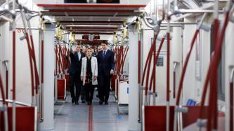 Prime Minister Justin Trudeau, Premier Kathleen Wynne, Mayor John Tory walk in a new subway car