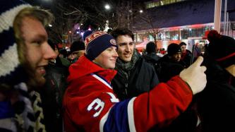 Prime Minister Justin Trudeau poses for a selfie photograph with Montreal Canadiens' fan