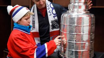 Prime Minister Justin Trudeau and his son Xavier examine the Stanley Cup