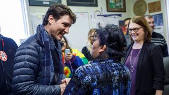 Prime Minister Justin Trudeau and Minister Jane Philpott are greeted by members of the Council of Pikangikum First Nation.