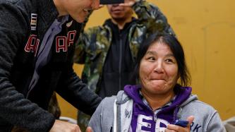 Prime Minister Justin Trudeau shakes hands with a member of the Pikangikum community at the Community Centre.