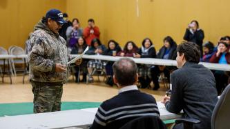 Prime Minister Justin Trudeau listens to a community elders' remarks during a public discussion.
