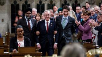 Prime Minister Justin Trudeau and Minister Harjit Singh Sajjan escort newly elected MP Gordie Hogg into the House of Commons for the first time