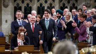 Prime Minister Justin Trudeau and Minister Seamus O’Regan escort newly elected MP Churence Rogers into the House of Commons for the first time