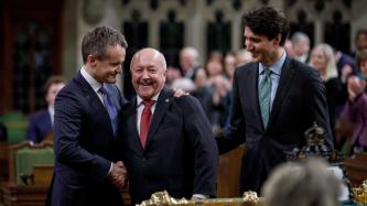 Minister Seamus O’Regan shakes hands with newly elected MP Churence Rogers in the House of Commons alongside Prime Minister Justin Trudeau