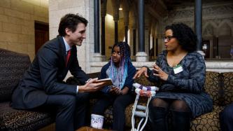 Prime Minister Justin Trudeau speaks with author Sherylee Honeyghan and her daughter Sheriauna in Ottawa.