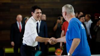 PM Trudeau shakes hands with a man