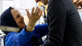 Prime Minister Justin Trudeau hugs Houria, a quality control reviewer at Les Petites-Mains