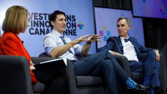 Prime Minister Justin Trudeau speaks while Bill Nye and MP Kate Young look on during an armchair discussion at the University of Ottawa